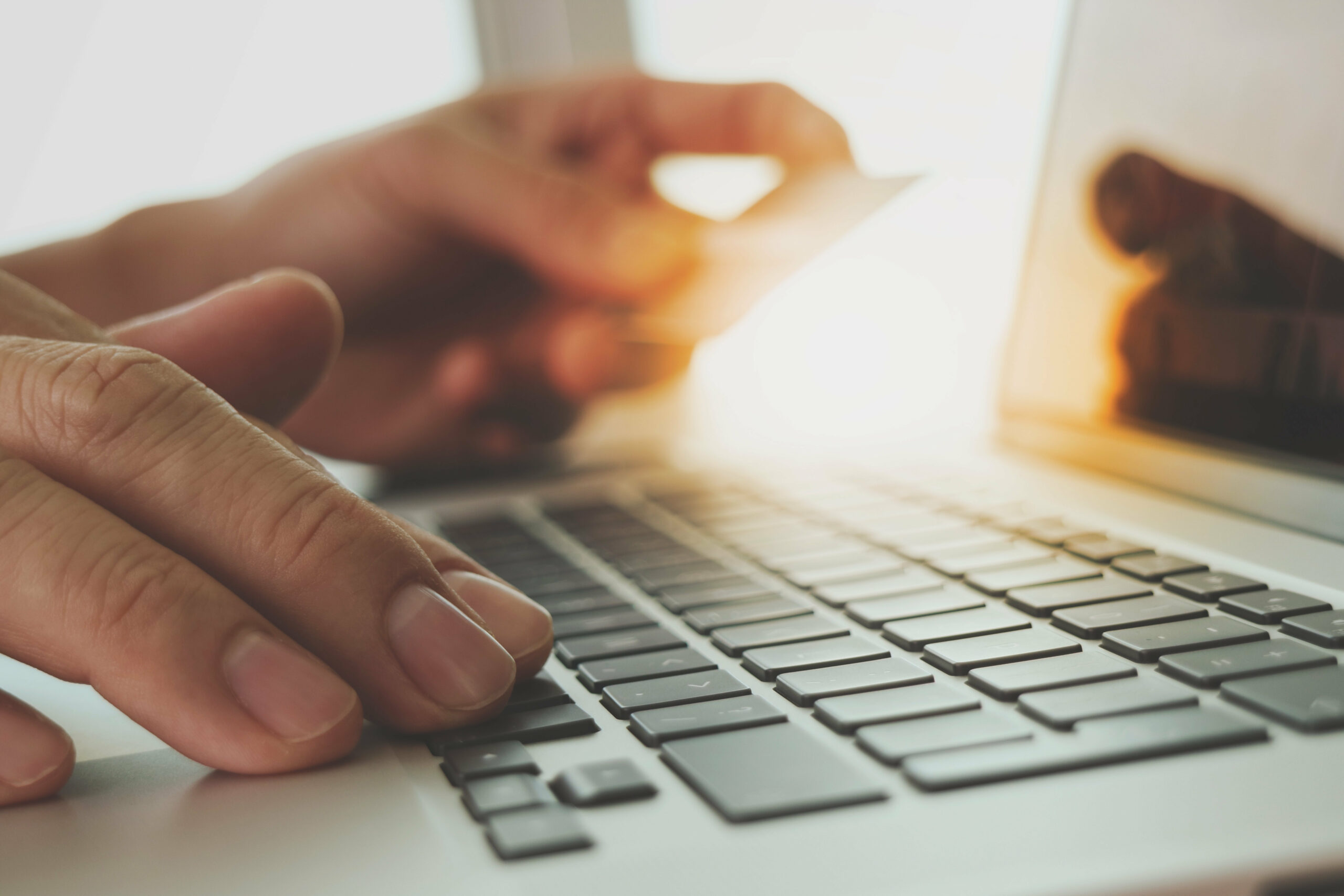 hands using laptop and holding credit card with digital business layers diagram as Online shopping concept